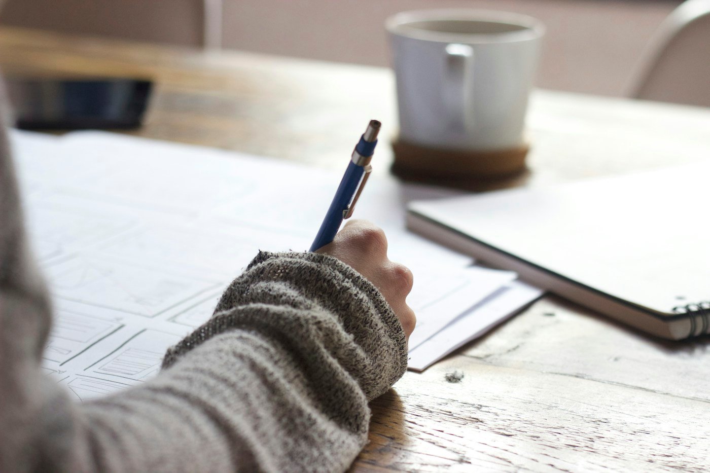A learner taking notes during a study session